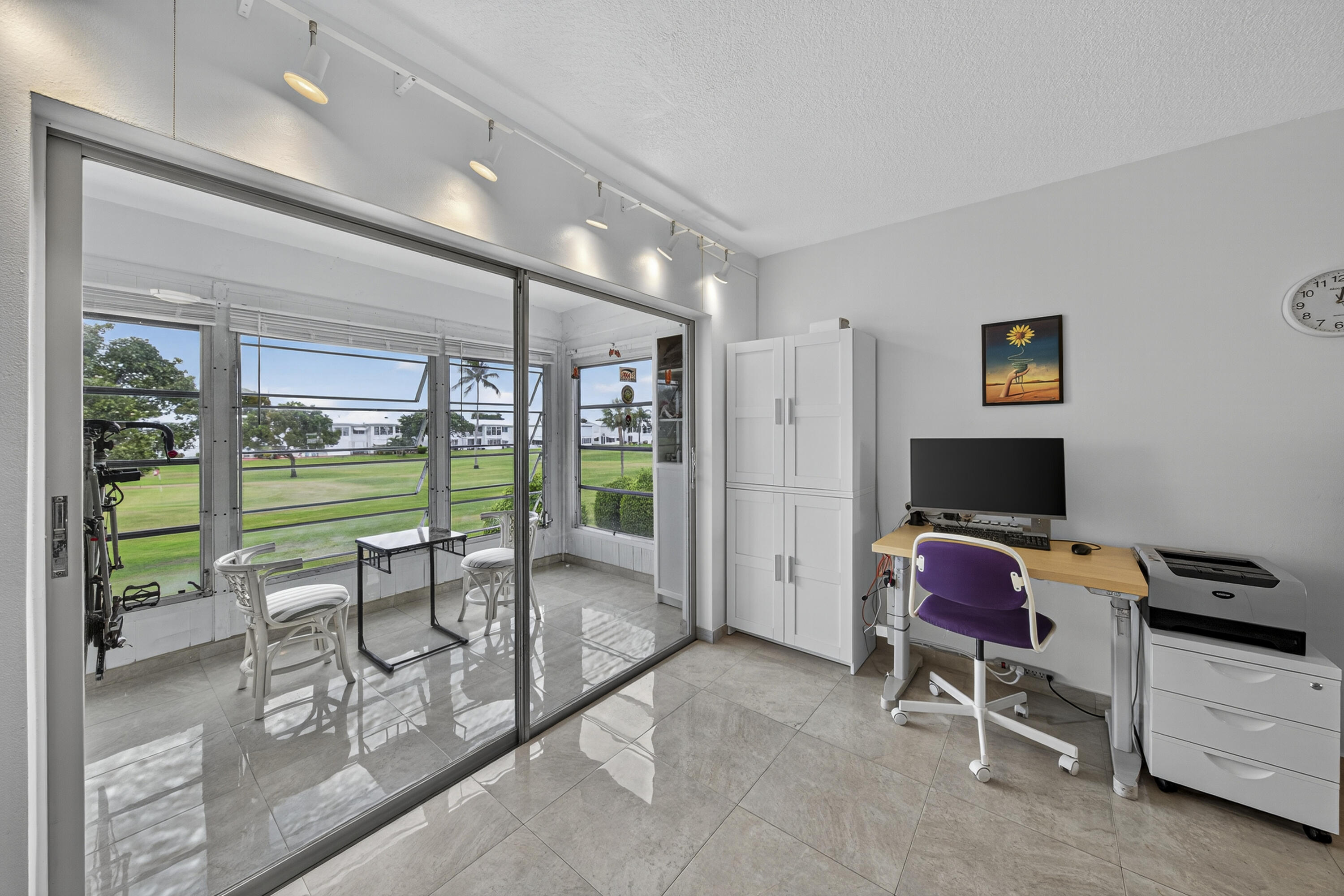 251 South Golf Boulevard, Unit 287 Pompano Beach, FL 33064 - Photo 6 of 63 a view of a room with gym equipment and floor to ceiling window