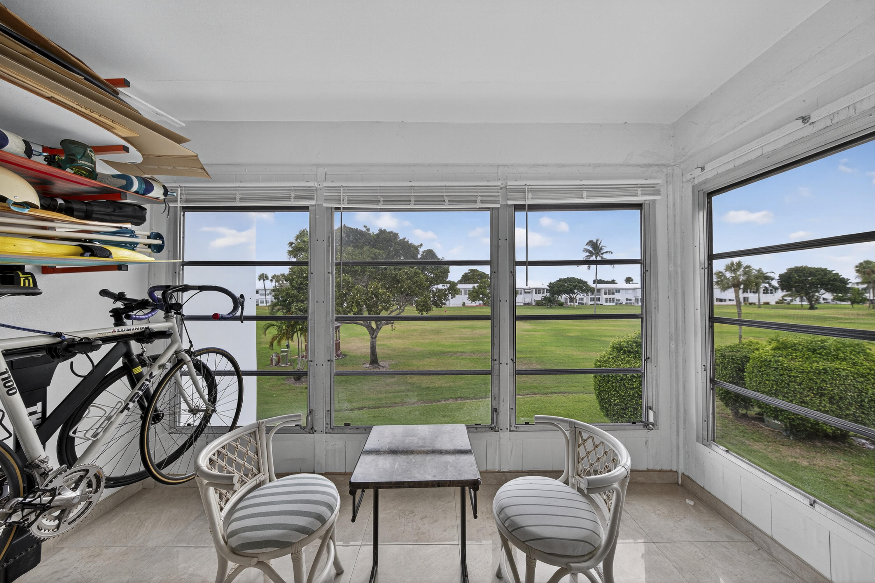 251 South Golf Boulevard, Unit 287 Pompano Beach, FL 33064 - Photo 7 of 63 a living room with furniture and a floor to ceiling window