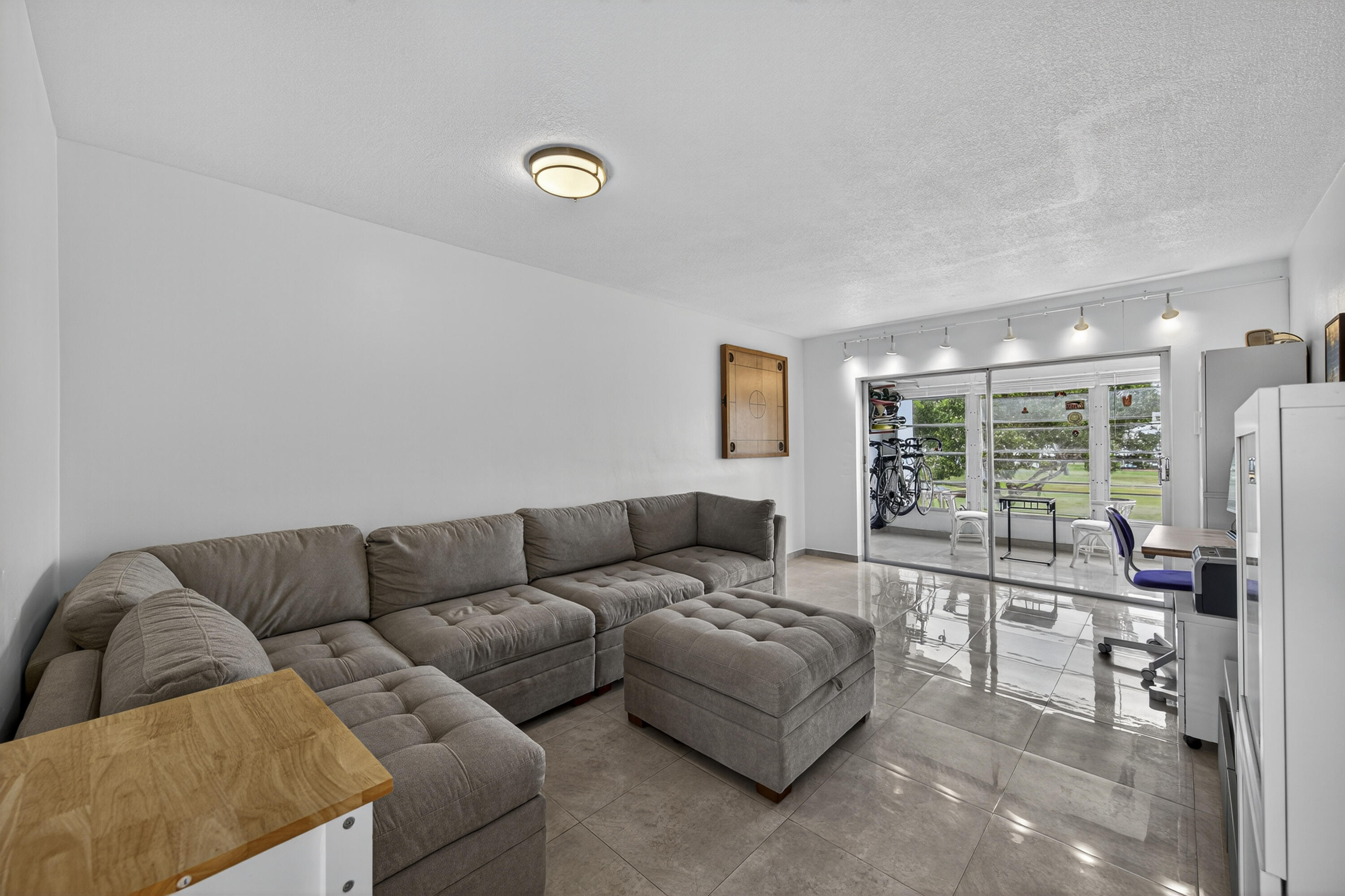 251 South Golf Boulevard, Unit 287 Pompano Beach, FL 33064 - Photo 10 of 63 a living room with furniture and a large window