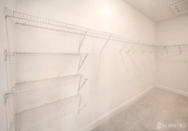 a spacious bedroom with a bed and a chandelier