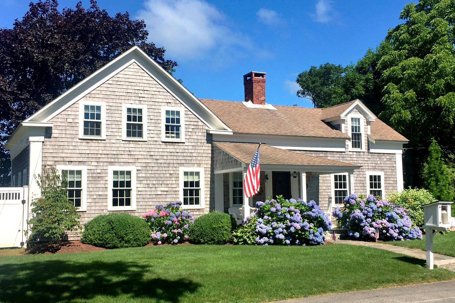 368 Stage Harbor Road Chatham, MA 02633 - Photo 1 of 41 a front view of a house with a yard