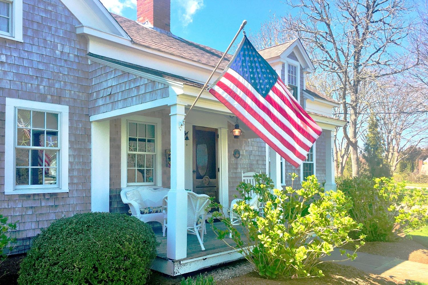 368 Stage Harbor Road Chatham, MA 02633 - Photo 2 of 41 a front view of a house with a yard and potted plants