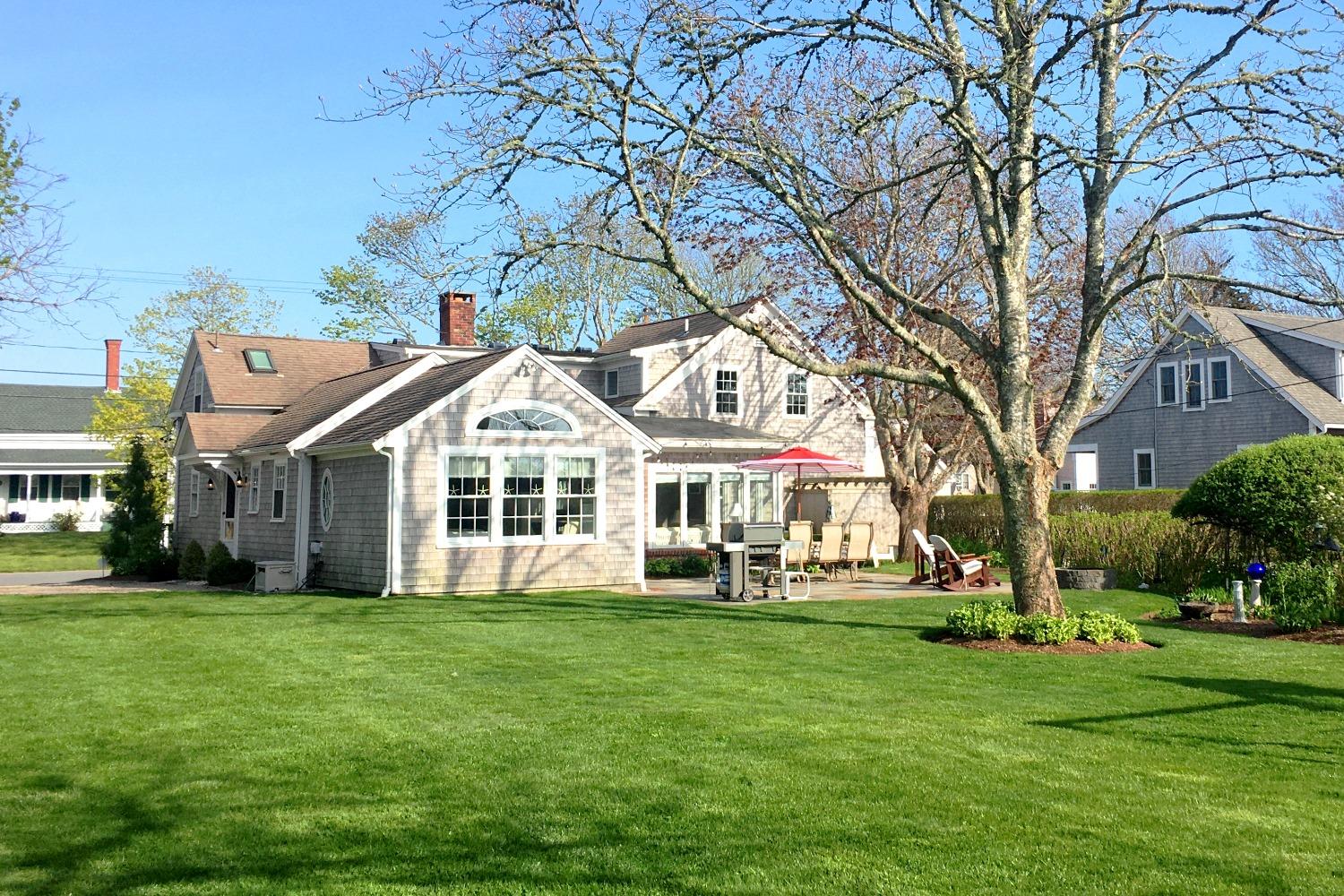 368 Stage Harbor Road Chatham, MA 02633 - Photo 4 of 41 a front view of a house with a garden and trees