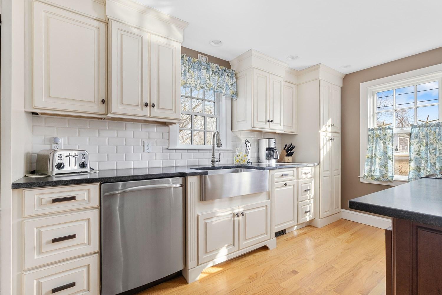 368 Stage Harbor Road Chatham, MA 02633 - Photo 8 of 41 a kitchen with white cabinets and white appliances