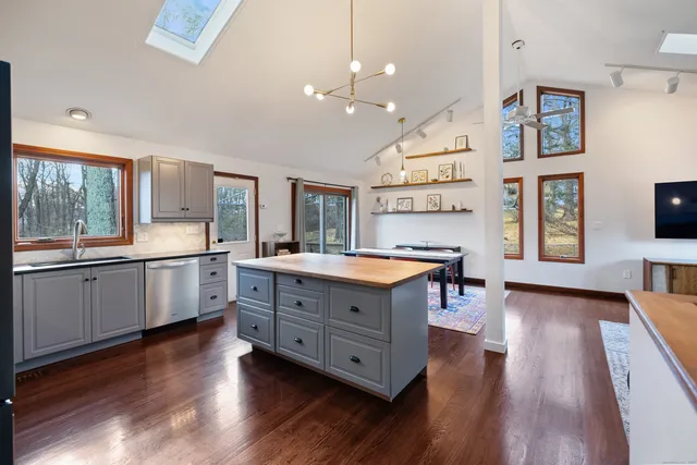 a kitchen with stainless steel appliances granite countertop a lot of counter space and a sink