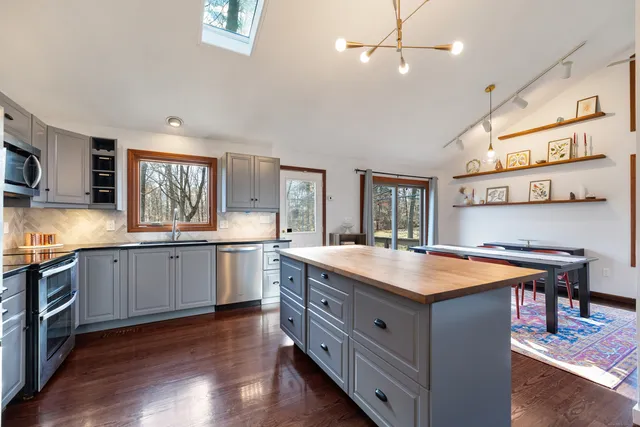 a kitchen with a stove a sink and a refrigerator