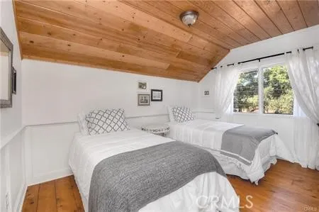 a bedroom with two beds and a large window