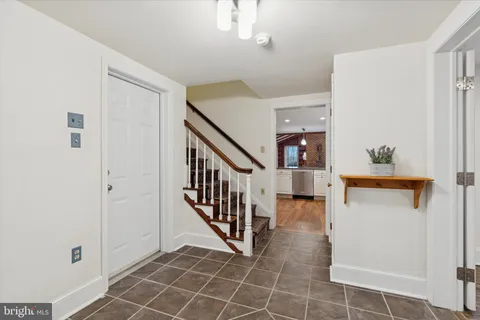 a view of a room with wooden floor and a window