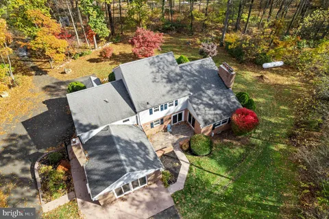an aerial view of a house with a yard and lake view