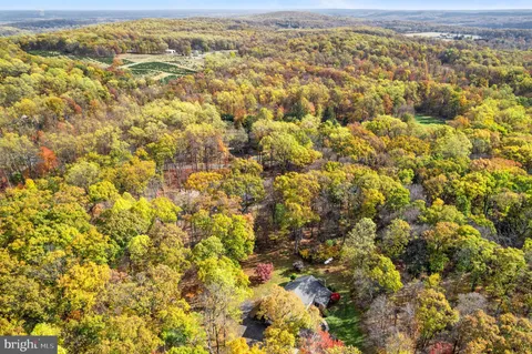 a aerial view of a house with a yard and garden