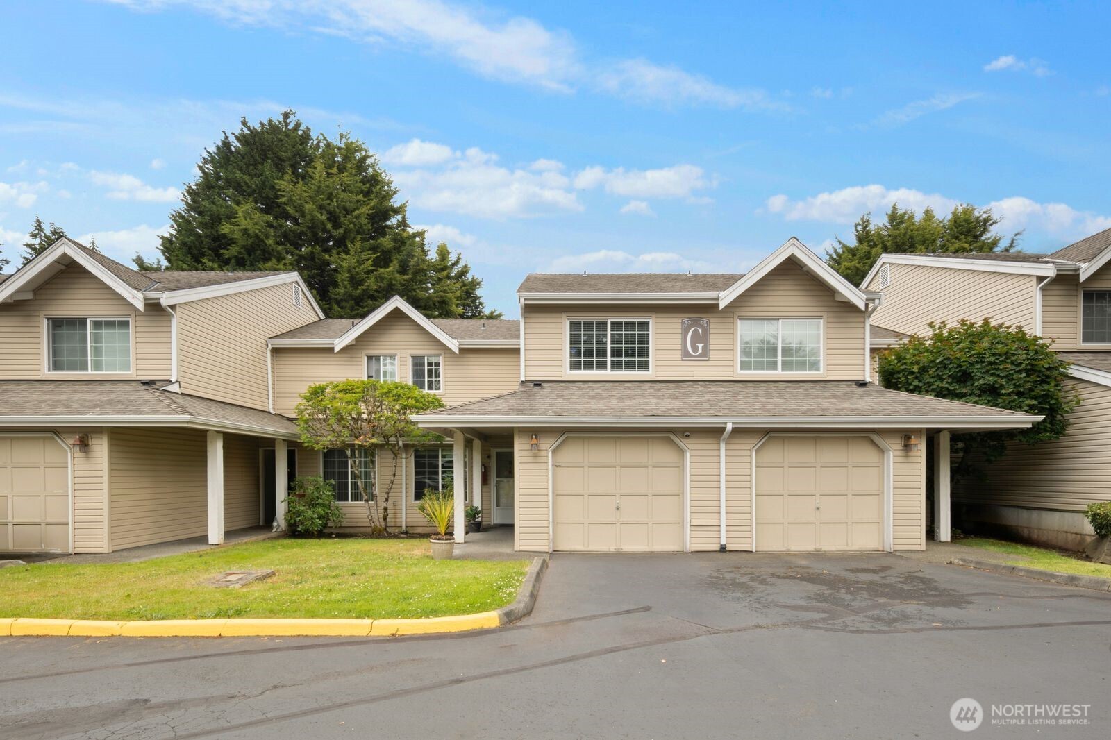 a front view of a house with a yard and garage