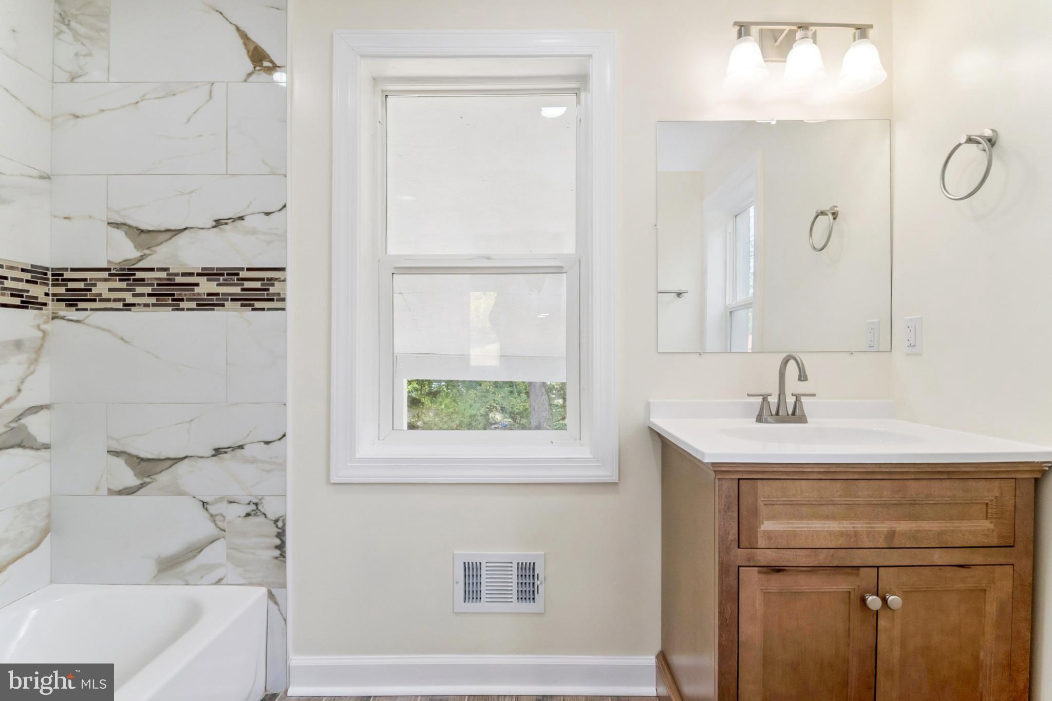 6804 Carol Road Baltimore, MD 21207 - Photo 11 of 25 a bathroom with a sink and a bathtub