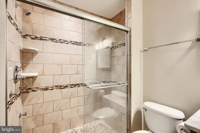 a bathroom with a toilet and a shower