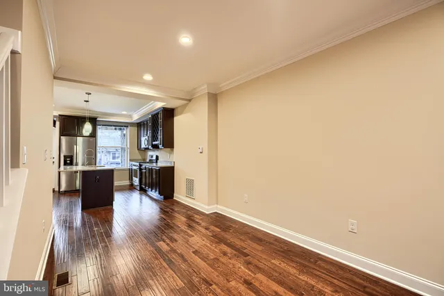 a view of kitchen with furniture and wooden floor