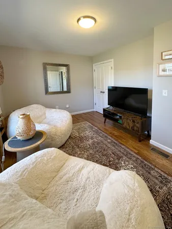 a bedroom with two beds and a flat screen tv