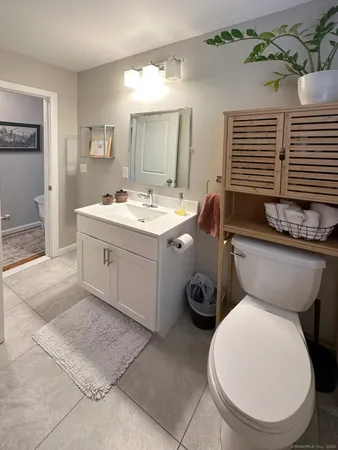 a bathroom with a toilet sink and mirror