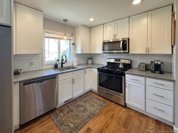 a kitchen with a sink stove and microwave