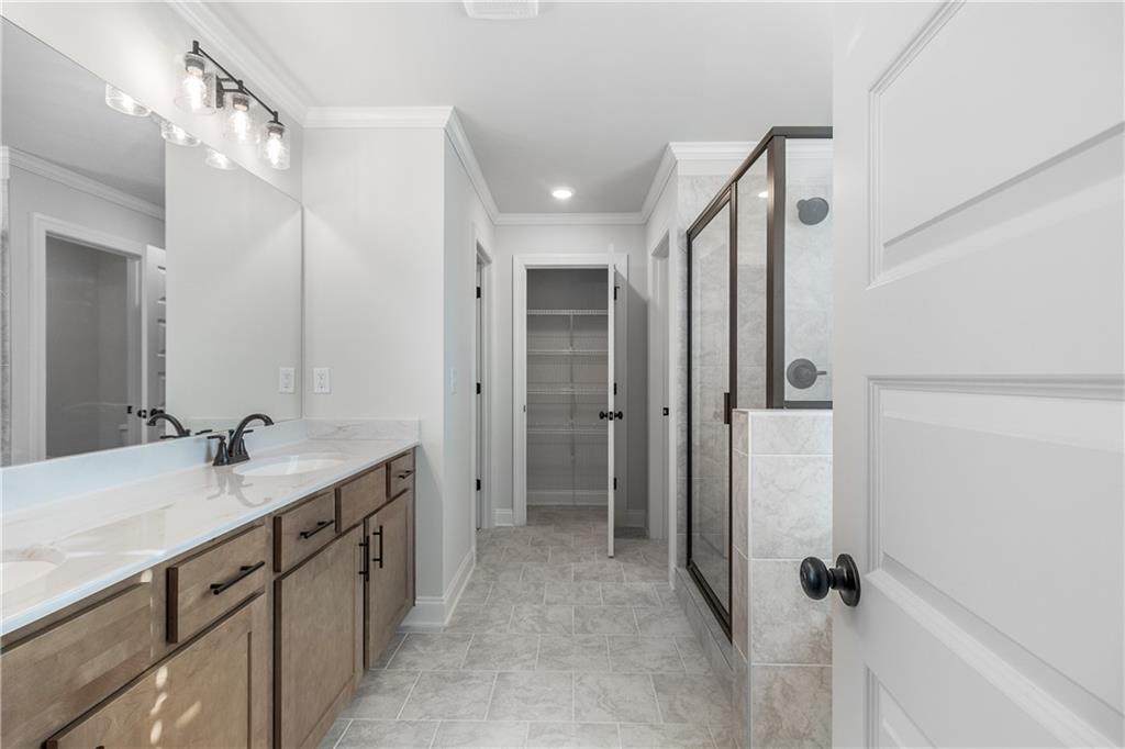 448 Banff Drive Winder, GA 30680 - Photo 12 of 16 a bathroom with a double vanity sink a mirror and shower