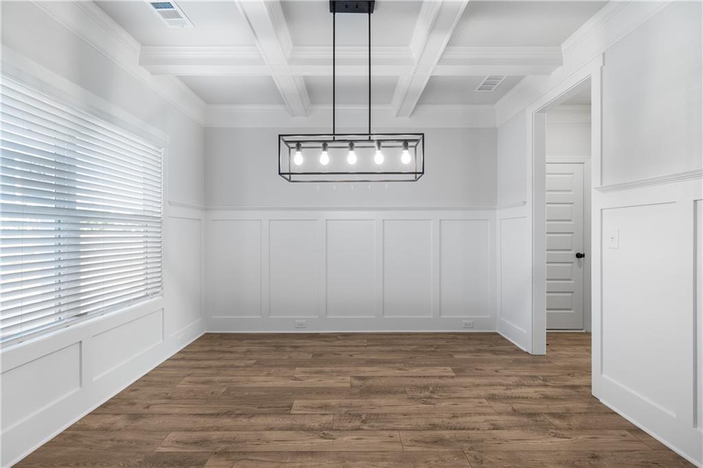 448 Banff Drive Winder, GA 30680 - Photo 2 of 16 an empty room with wooden floor chandelier and windows