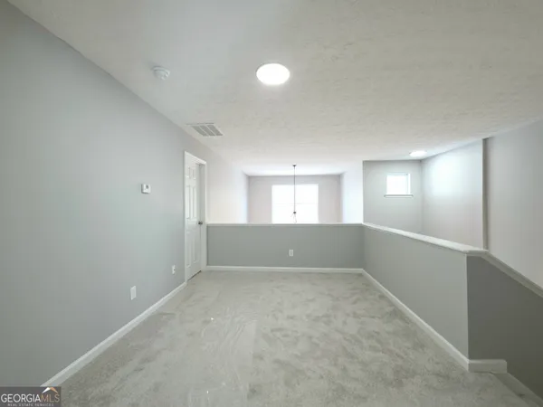 an empty room with windows and entrance
