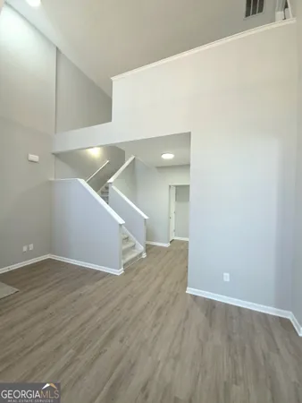 a view of an empty room with wooden floor