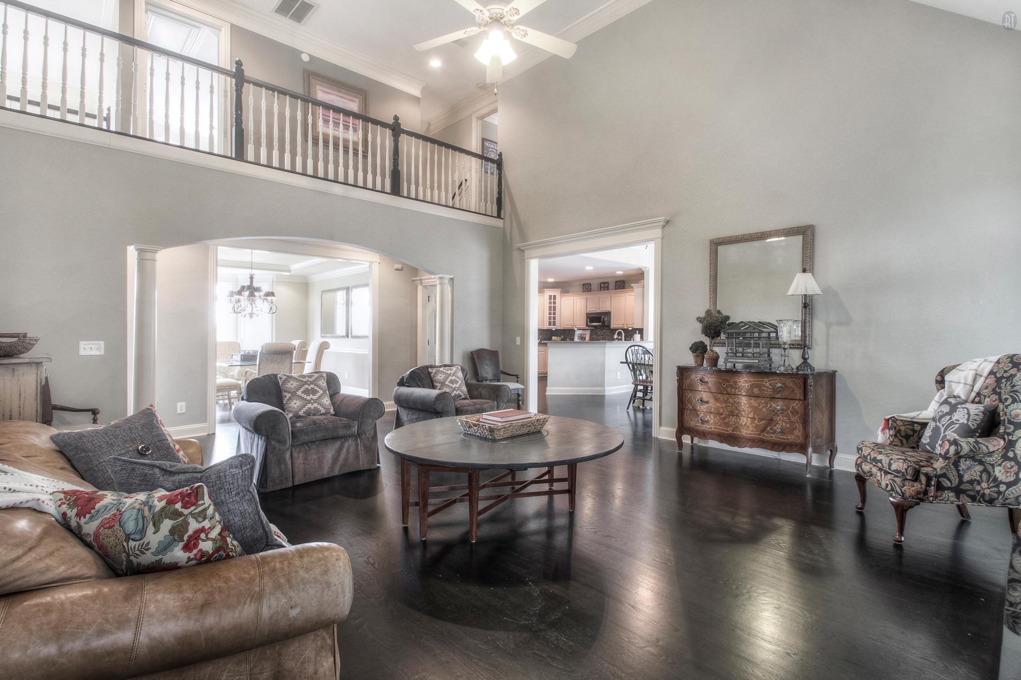 228 Halberton Drive Franklin, TN 37069 - Photo 1 of 23 a living room with couches and a dining table with kitchen view
