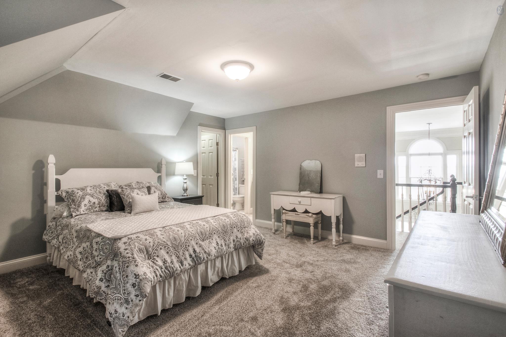 228 Halberton Drive Franklin, TN 37069 - Photo 14 of 23 a bedroom with a large bed and a chandelier