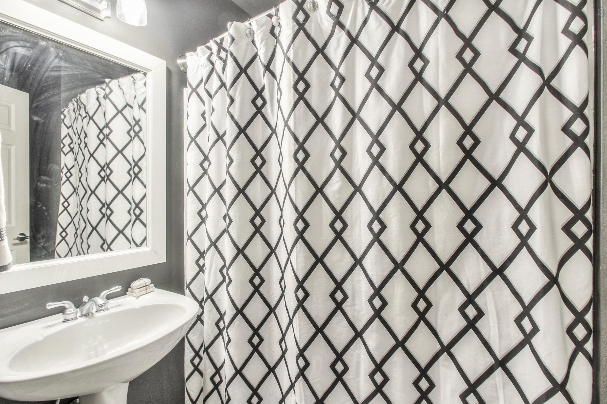 228 Halberton Drive Franklin, TN 37069 - Photo 18 of 23 a bathroom with a sink a vanity and a shower curtain