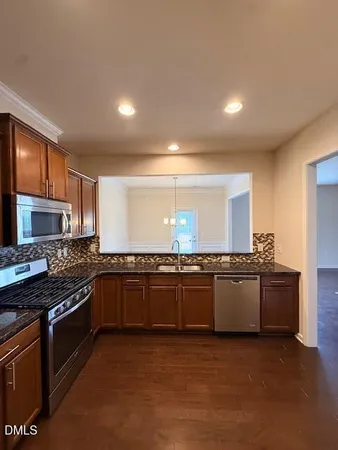 a kitchen with stainless steel appliances granite countertop a stove and a granite counter tops