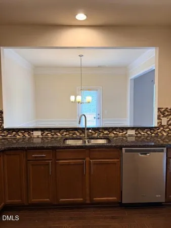 a kitchen with granite countertop a sink and cabinets