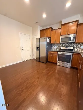 a kitchen with stainless steel appliances a refrigerator a stove a sink and dishwasher