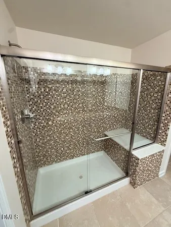 a bathroom with a bathtub and shower
