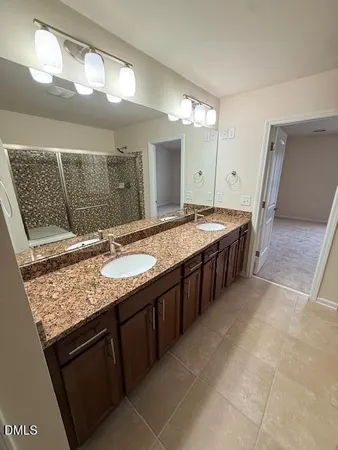 a bathroom with a granite countertop sink a mirror and a bathtub