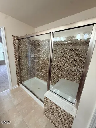 a bathroom with a shower and a toilet