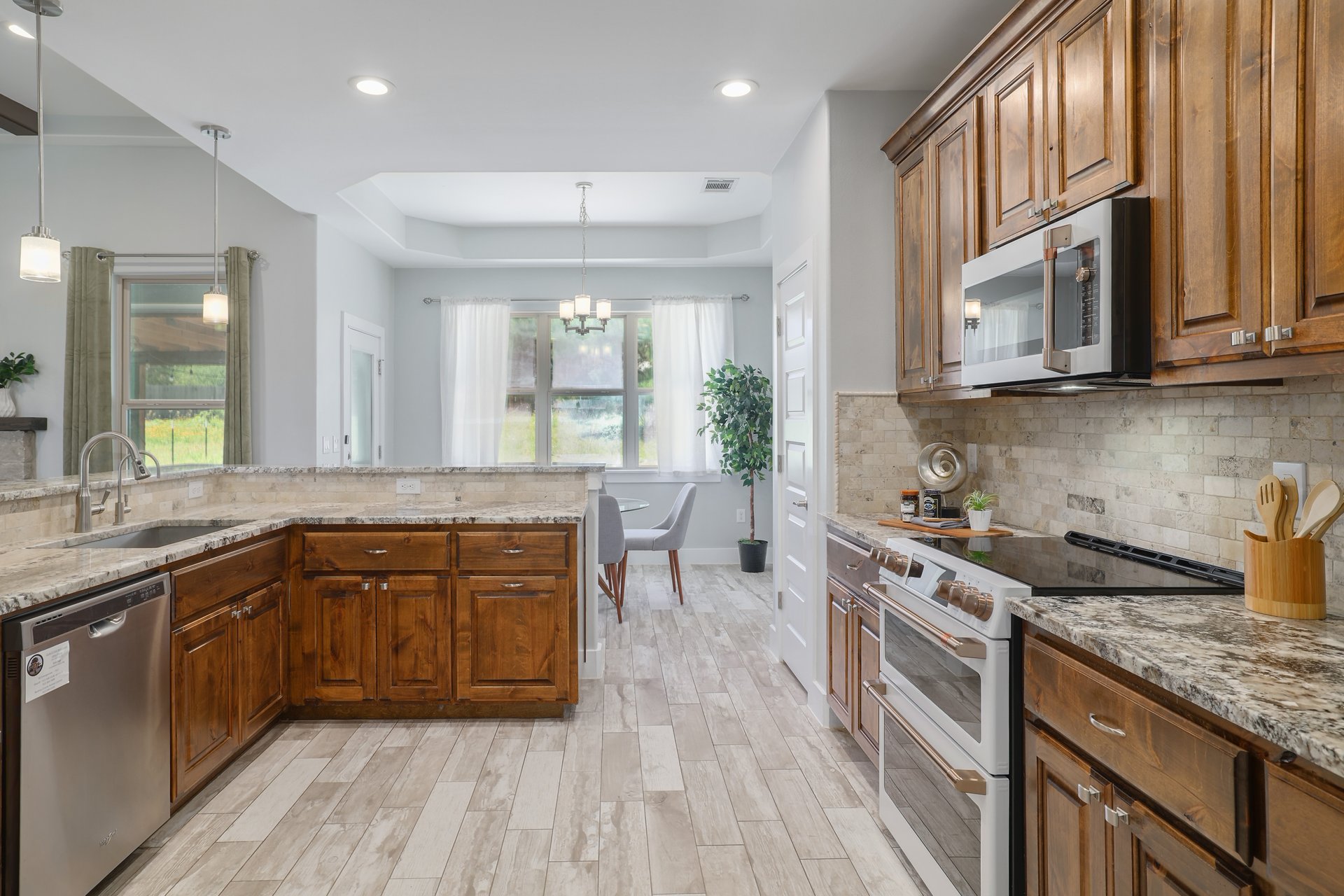 258 County Road Bastrop, TX 78602 - Photo 8 of 32 a kitchen with stainless steel appliances granite countertop wooden floor sink stove and a granite counter top