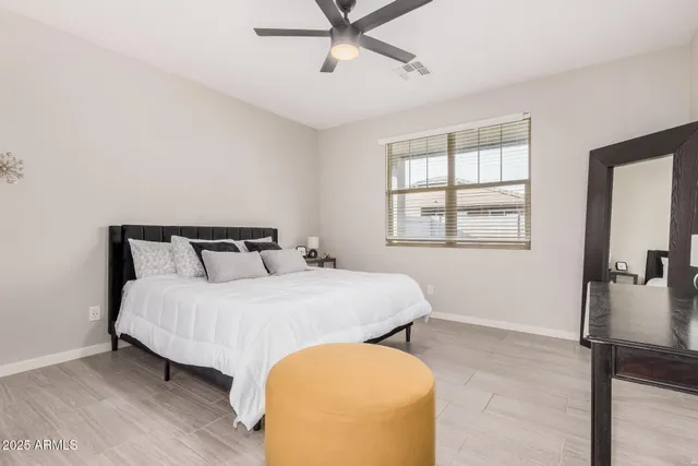 a bedroom with a bed and a window