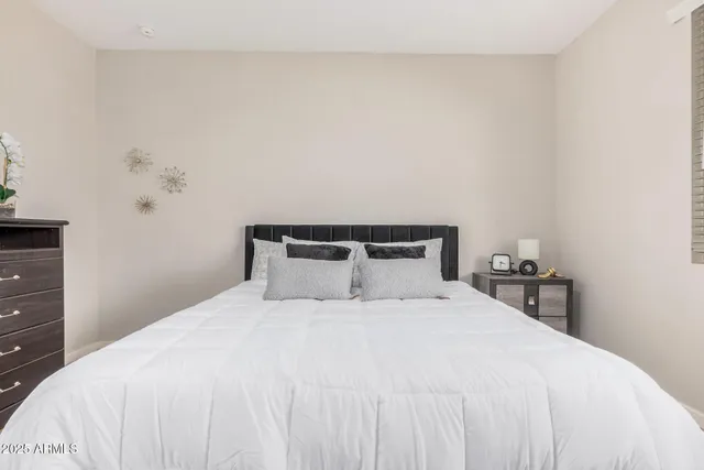 a bedroom with a bed and window