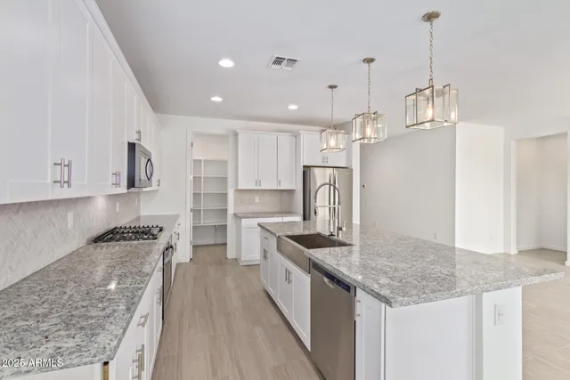 a spacious bathroom with a double vanity sink a mirror and a shower