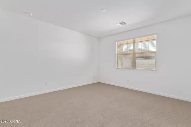 an empty room with a empty space and a ceiling fan