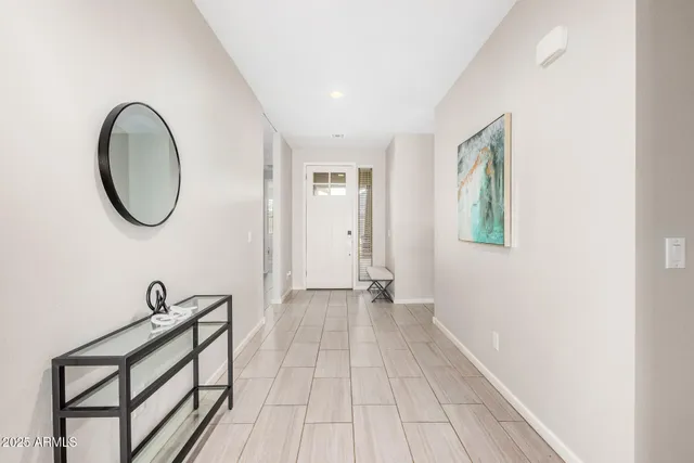 a kitchen with stainless steel appliances granite countertop a sink dishwasher a refrigerator a stove a oven a kitchen island with chairs and cabinets