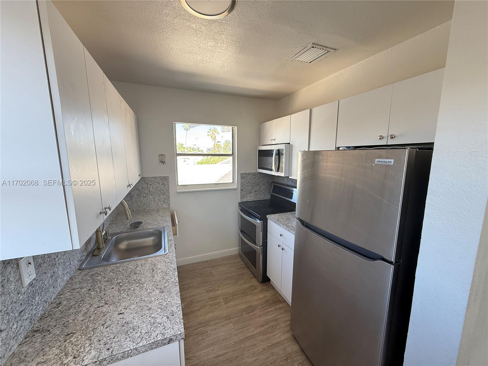 236 Southwest 10th Avenue Miami, FL 33130 - Photo 8 of 15 a kitchen with a refrigerator sink and stove