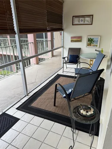 a view of a swimming pool with outdoor seating