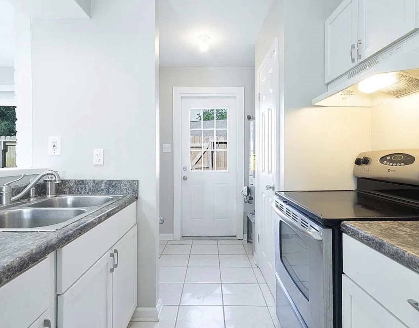1965 Campbell Road, Unit 1965 Houston, TX 77080 - Photo 7 of 13 a kitchen with granite countertop a sink and a stove