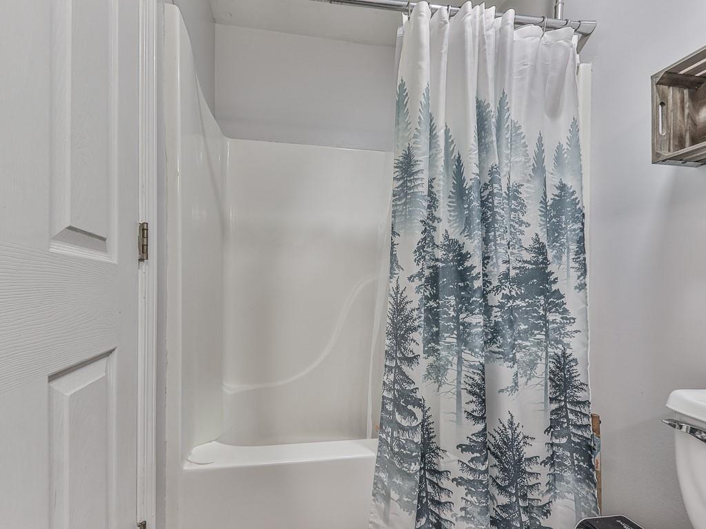 68 Arbor Hills Road South Talking Rock, GA 30175 - Photo 12 of 36 a bathroom with a shower curtain and a toilet