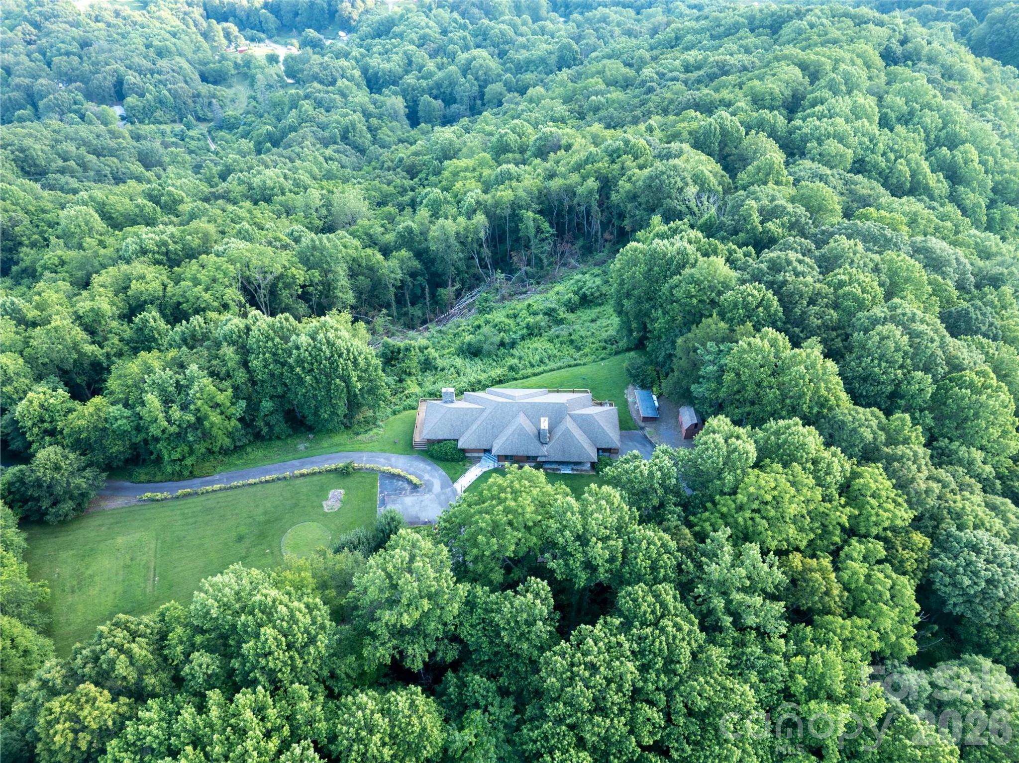 1087 Brigadoon Drive Clyde, NC 28721 - Photo 34 of 42 an aerial view of residential house with outdoor space and trees all around