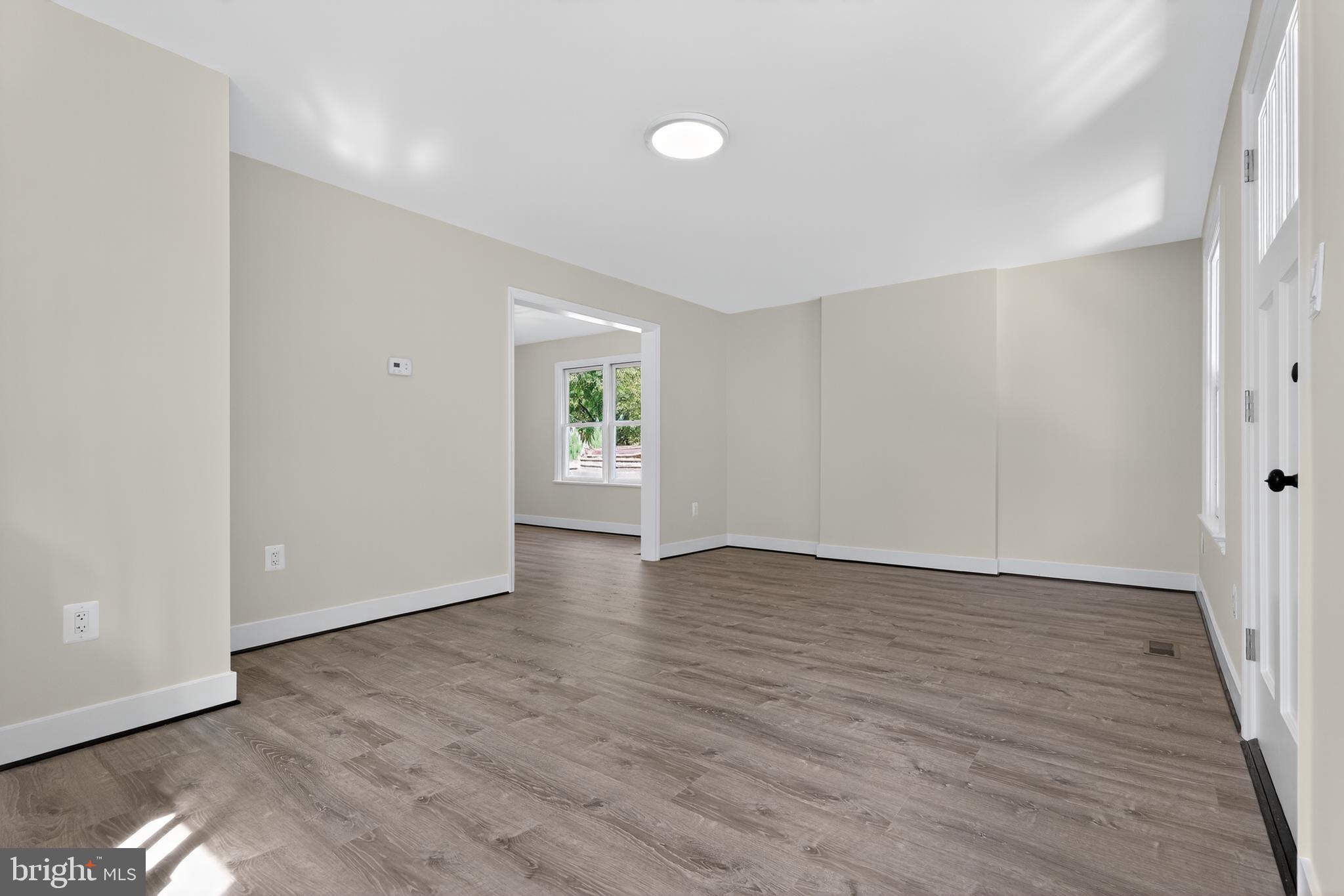 10612 Honeyfield Road Williamsport, MD 21795 - Photo 6 of 19 a view of an empty room with wooden floor and a window
