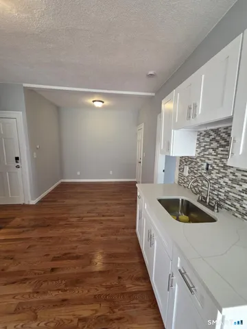 a kitchen with kitchen island a sink and refrigerator