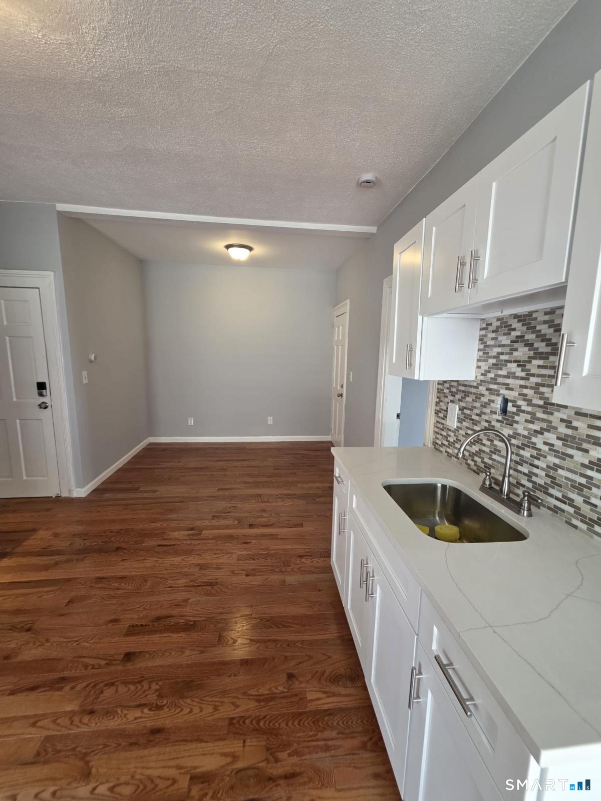 282 Pequonnock Street, Unit 2 Bridgeport, CT 06604 - Photo 3 of 7 a kitchen with kitchen island a sink and refrigerator