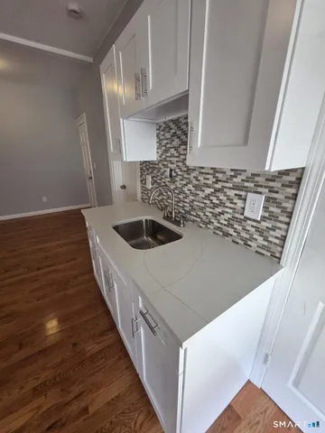 a kitchen with a sink and cabinets