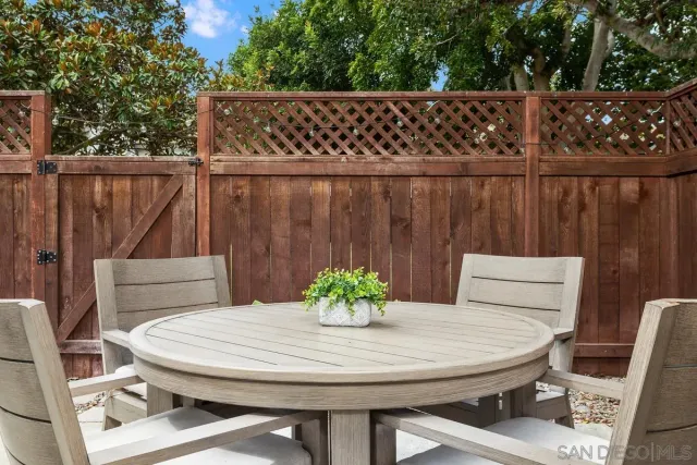 a table with chairs and wooden floor